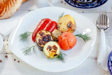 White plate with grilled vegetables.