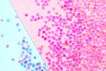 Confetti on abstract geometric paper background, festive concept.