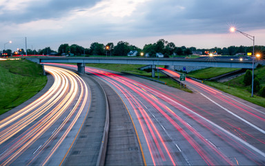 Streaming car lights from a long exposure over looking highway traffic during rush hour at dusk, suggest high speed connectivity.