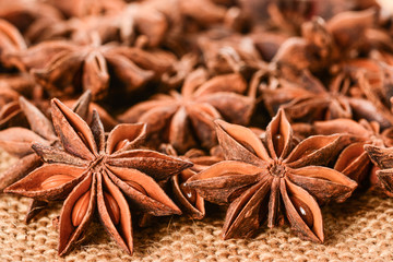 Star anise. Some star anise fruits with seeds 5. Macro close up on the jute burlap canvas.