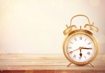 Retro alarm clock on table  background