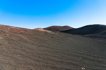 Timanfaya volcanoes park, Lanzarote, Canary Islands, Spain. Unique panoramic view of spectacular lava sand and ashes from huge volcano crater creates a lunar landscape on planet earth.
