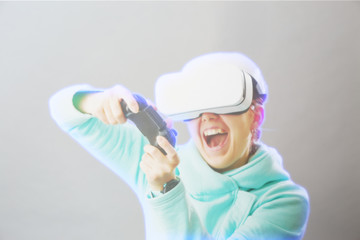 Fototapeta na wymiar Woman with virtual reality headset is playing game. Image with hologram effect.