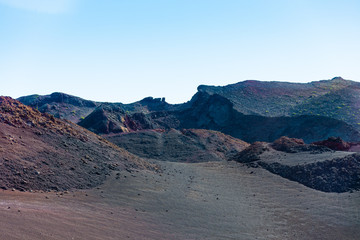 Naklejka premium Timanfaya National Park, Lanzarote, Canary Islands, Spain. Unique panoramic view of spectacular lava river flows from a huge volcano crater creates a lunar landscape on planet earth.