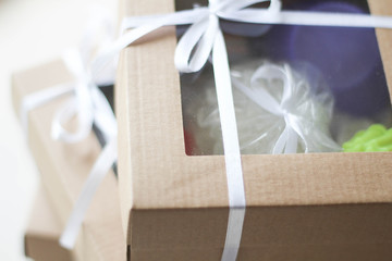 Brown paper packages with white ribbon. Christmas holiday gift box. Wrapping Christmas presents and...