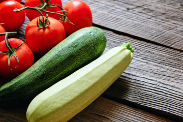 Zucchini and tomato on wood background copyspace