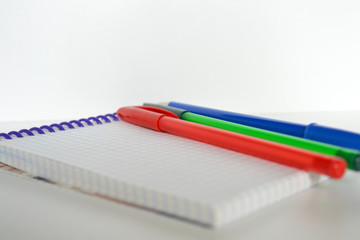 pencils and notebook on white background