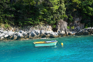 Fototapeta na wymiar Traditional fishing boat in turquoise water off Adriatic Sea on the coast of an island Croatia. Famous sailing travel destination in Croatia, Island Hvar summer scenery in Europe.