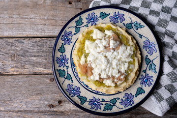 Mexican food: sopes with green sauce and beans