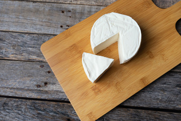 Fresh and tasty mexican panela cheese on wood background