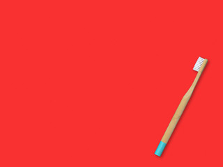 Bamboo toothbrush on colorful background