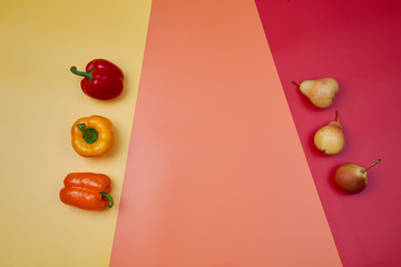 Colorful fruit pattern or background. Pears and peppers placed on colorful background