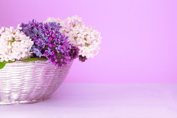 Lush multicolored bouquet of lilac flowers in a blurred purple background. Pastel greeting card concept. Copy space.