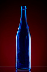 Dark glass bottle on red background