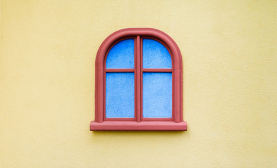 Red window on yellow wall