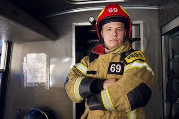 Photo of man fireman on background of fire truck