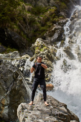 Muay thai fighter training by the waterfall