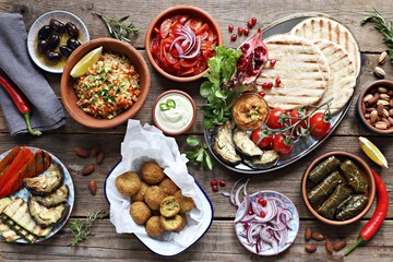 Middle eastern, arabic or mediterranean appetizers table concept with falafel, pita flatbread,...