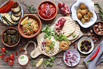 Middle eastern, arabic or mediterranean appetizers table concept with falafel, pita flatbread,...