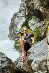 Muay thai fighter training by the waterfall