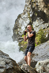 Muay thai fighter training by the waterfall