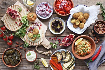 Middle eastern, arabic or mediterranean appetizers table concept with falafel, pita flatbread,...
