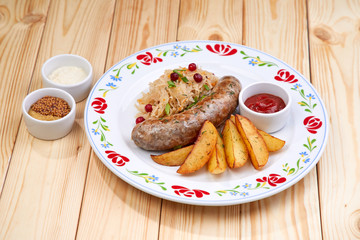 sausage with baked potatoes and sauce