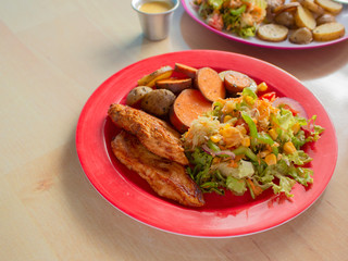 Smoked Grilled Chicken with BBQ Sauce and a mix of Potatoes and Sweet Potatoes and Green Salad with Yellow Corn