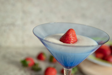 yogurt in a glass with a strawberry half flat