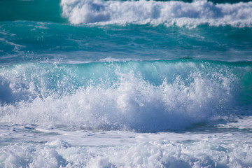 Detalle de olas rompiendo contra el mar y las rocas.