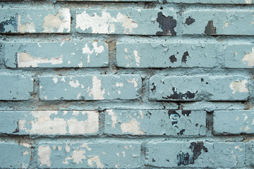 Aquamarine brick wall with splashes of paint. Dilapidated stone walls in the style of grunge