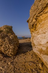 Passage between the rocks on the sandy beach