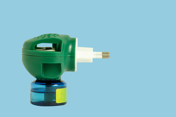 Fumigator green isolated on blue background. Mosquito repellent, insect repellent.
