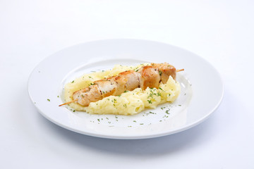 chicken kebab with mashed potato on the white plate