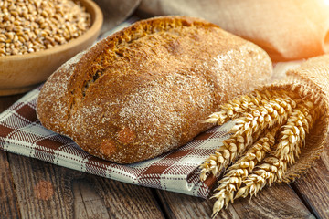 loaf of bread on wooden background, food closeup.Fresh homemade bread.French bread. Bread at leaven. Unleavened bread.Ciabatta bread.