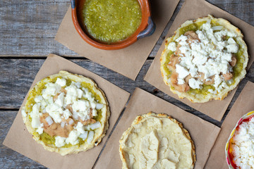 Mexican food: sopes with green sauce and beans