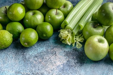 Fototapeta na wymiar Green apples, celery and limes on a concrete background. Detox program, diet plan, weight loss. Flat lay composition.