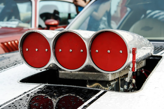 white stripes on the hood and turbo supercharger with red drosels on american the muscle car