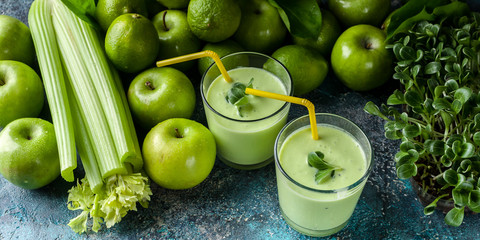 Smoothies: milk thistle green and green fruits on a concrete background. Food detox banner.