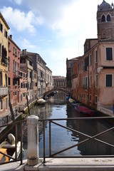 View of the canal in Venice, old buildings and small bridges.