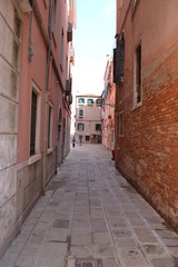 Fototapeta na wymiar Street in Venice, ancient buildings and pavement.