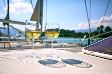 Pair of wineglasses against the yacht
