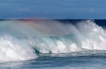 Beautiful Breaking Wave with rainbow colors in Hawaii