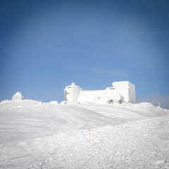 The destroyed Polish observatory is covered with snow on the top in the Carpathians