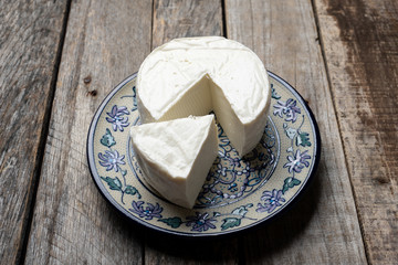 Fresh and tasty mexican panela cheese on wood background