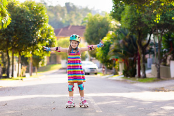 Child on inline skates. Kids skate roller blades.