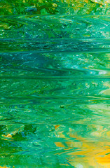 Abstract art texture background. Water surface in motion design. Beautiful green and yellow paint with ripple effect.