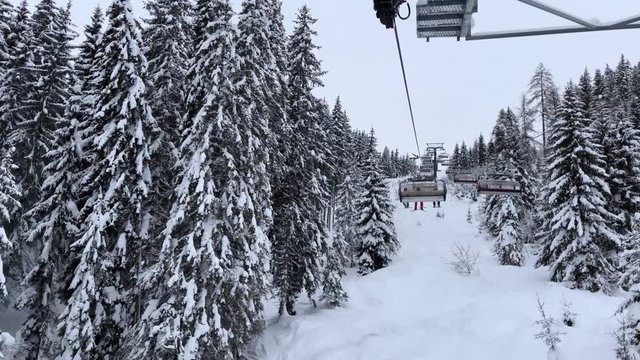 FPV: Riding a chairlift uphill in a ski resort in Flachau, Austria