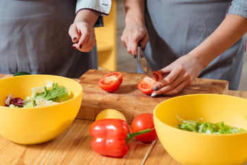 Women making salad. Healthy balanced nutrition eating habit vegan lifestyle. Females on diet preparing organic vegetables.