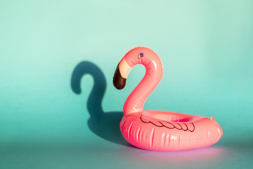 Giant inflatable Flamingo on a blue background, pool float party, trendy summer concept